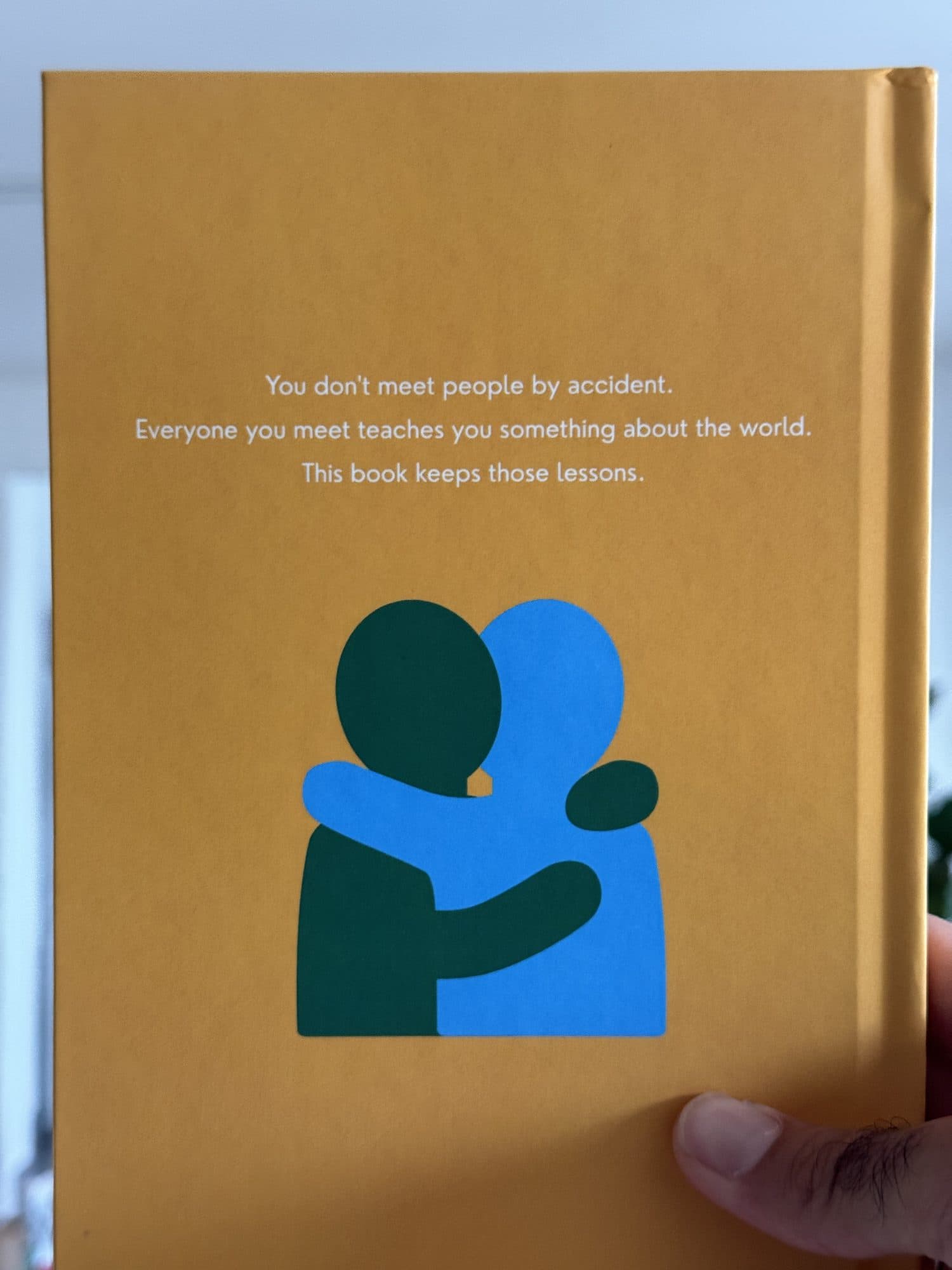 Back cover: you don't meet people by accident, above two figures hugging